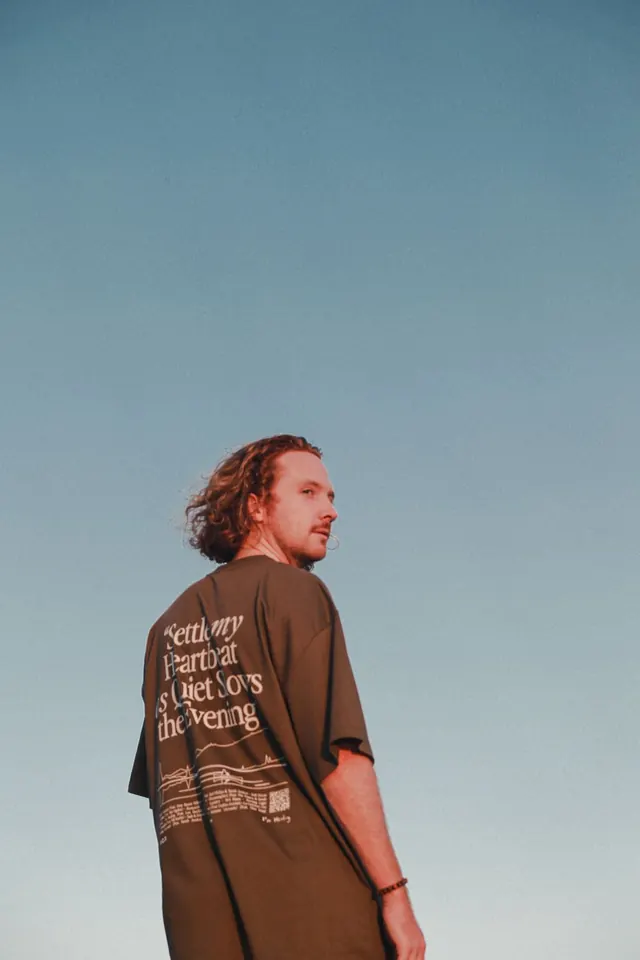 Ben looking back over his shoulder beneath the evening sky.