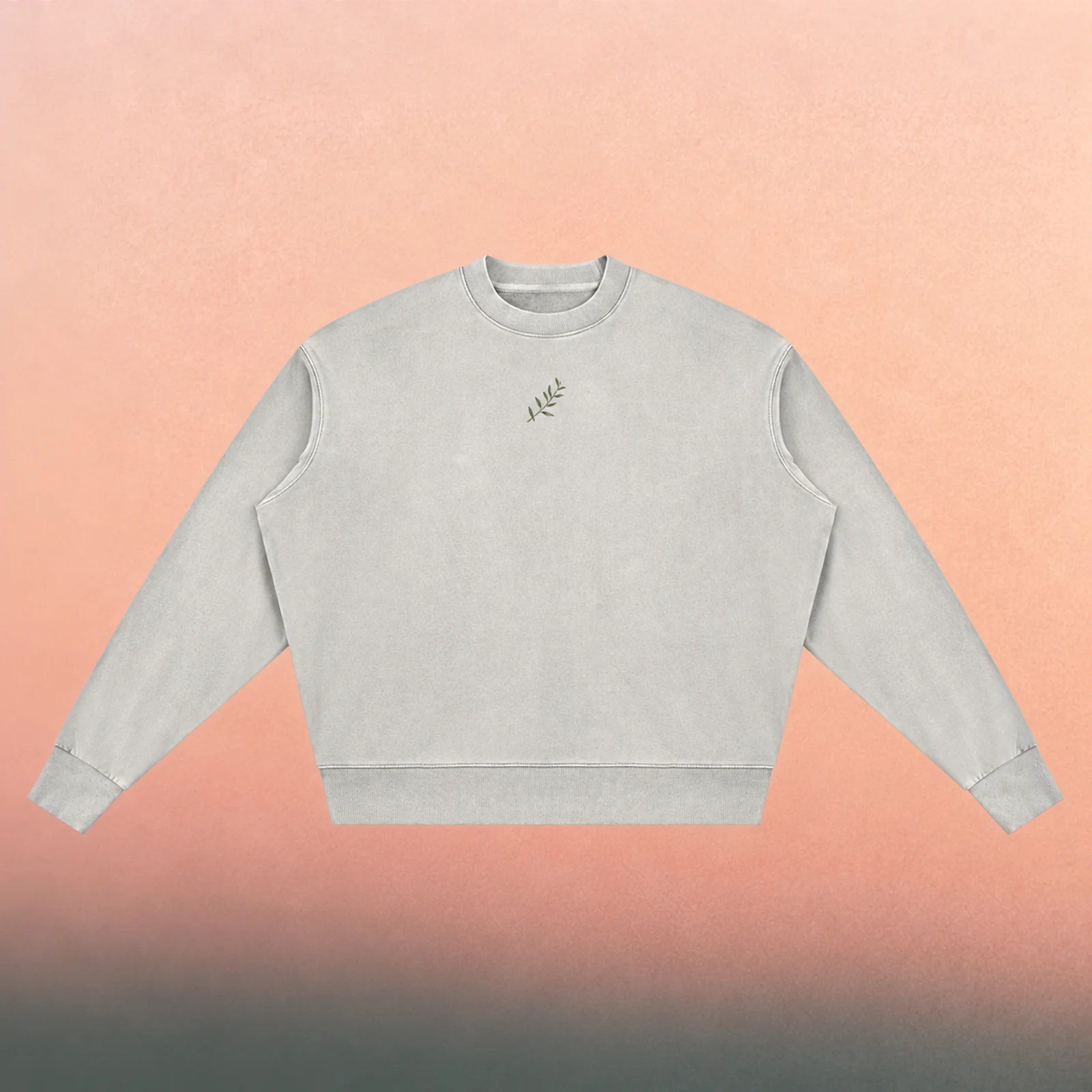 Front mockup — muted olive branch on a Light Gray vintage-washed crewneck, against a pearly peach background