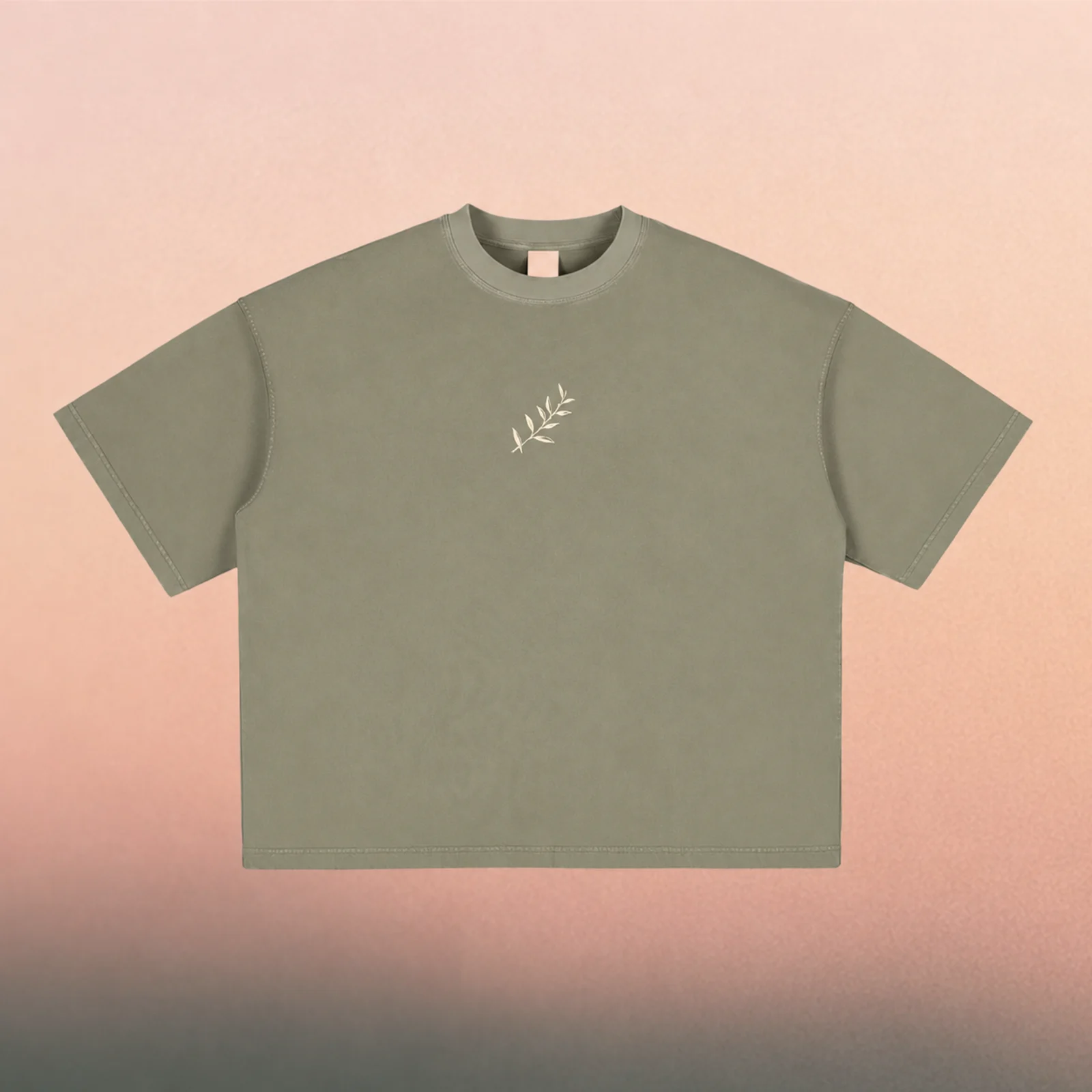 Front mockup — cream olive branch on a washed Gray Green boxy tee