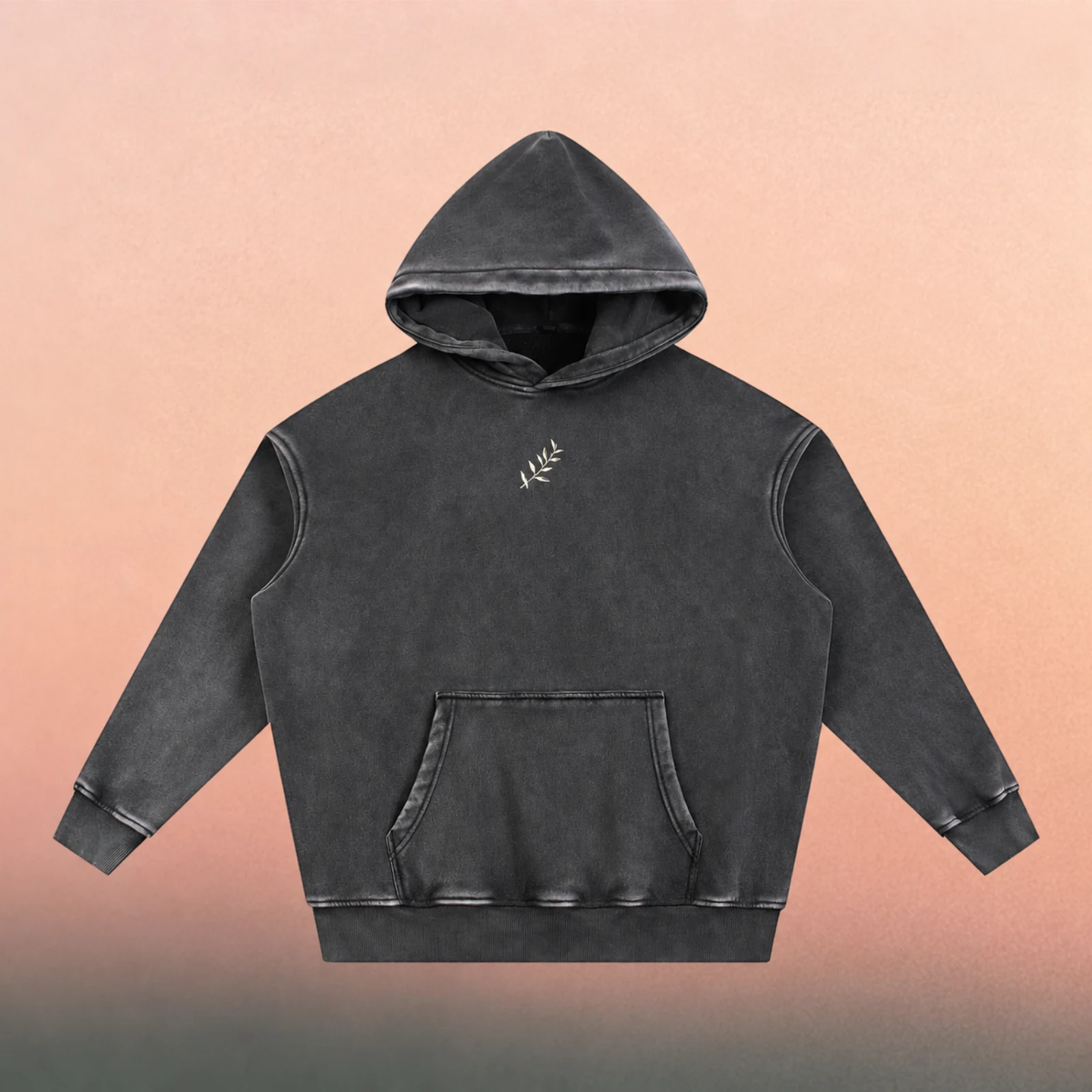 Front mockup — small cream olive branch on the snow-washed black hoodie